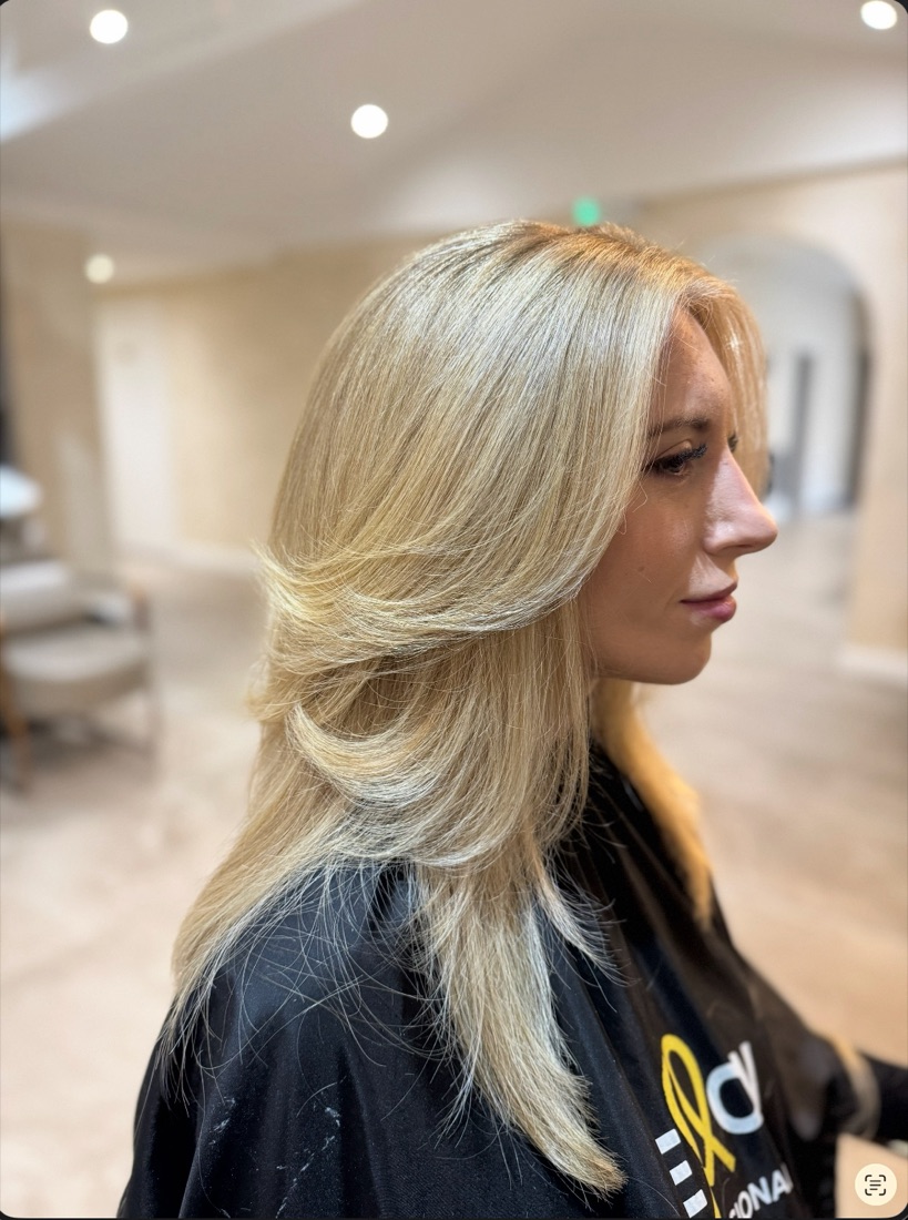 Hair colour after — bright, blended blonde with a layered cut